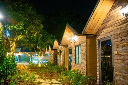 a row of houses at night with lights at MoCha House in Làng Môn