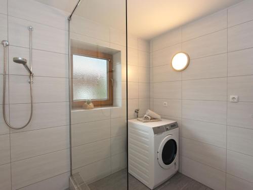 a bathroom with a washing machine and a shower at Holiday Home Sonnblick by Interhome in Uderns