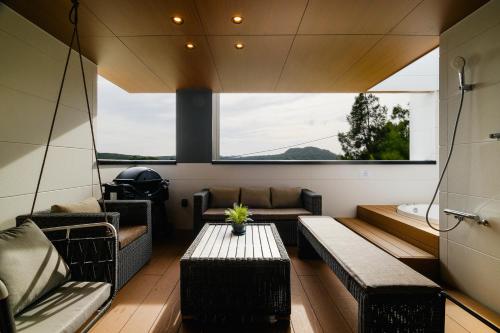 ein Zimmer mit Sofas und einem Tisch in einem Haus in der Unterkunft MIRATIO Sirius in Onna