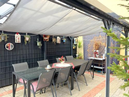 a patio with a table and chairs under a canopy at Apartment Gloggnitz by Interhome in Gloggnitz