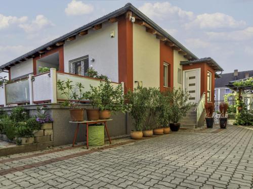 a house with potted plants in front of it at Apartment Gloggnitz by Interhome in Gloggnitz
