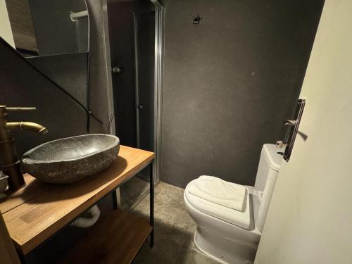 a bathroom with a sink and a toilet at The Old Mill Hotel Lapta in Kérynia