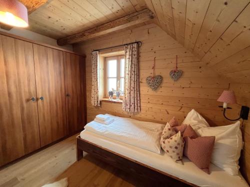 a bedroom with a bed in a wooden room at Holiday Home st martin chalets-1 by Interhome in Sankt Martin
