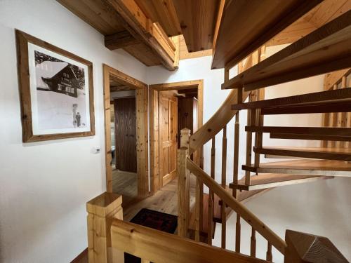 a staircase in a log home with wooden ceilings at Holiday Home st martin chalets-1 by Interhome in Sankt Martin