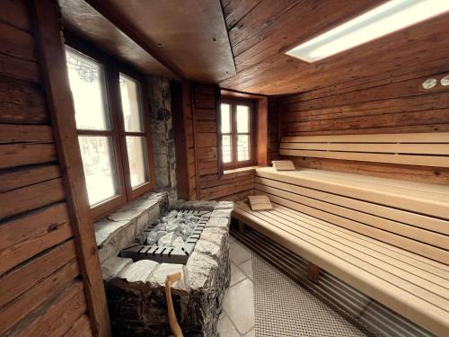a sauna with benches in a wooden cabin at Holiday Home st martin chalets-1 by Interhome in Sankt Martin