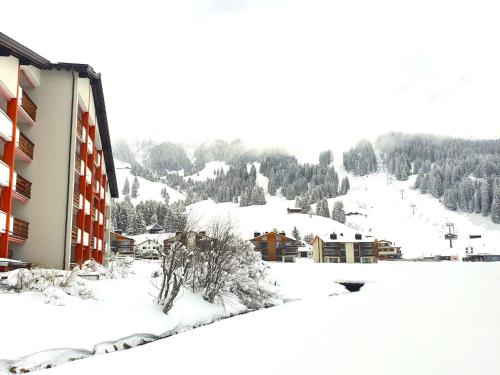 a snow covered building with a mountain in the background at Apartment Triangel A Mohr by Interhome in Parpan