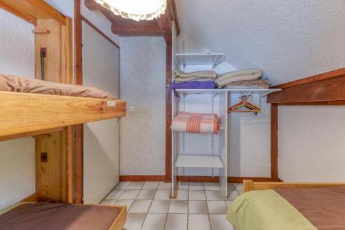 a small room with two bunk beds and a chair at Magnimon 2 - Le Charme Rustique in Villard-Reculas