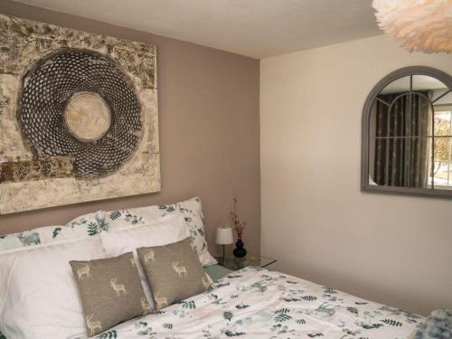 a bedroom with a bed and a painting on the wall at Apartment Spitzhorn Nr- 1 by Interhome in Gsteig