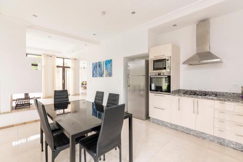 a kitchen with a dining room table and chairs at Villa Louda in Essaouira