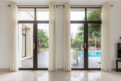 an open sliding glass door with a view of a pool at Villa Louda in Essaouira