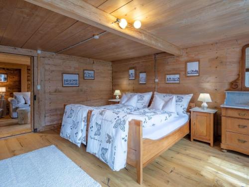 a bedroom with a bed in a wooden room at Apartment Chalet Bijou- 1 OG by Interhome in Lenk