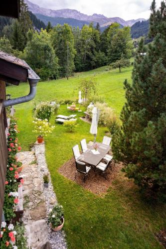 an overhead view of a garden with a table and chairs at Apartment Chalet Bijou- 1 OG by Interhome in Lenk