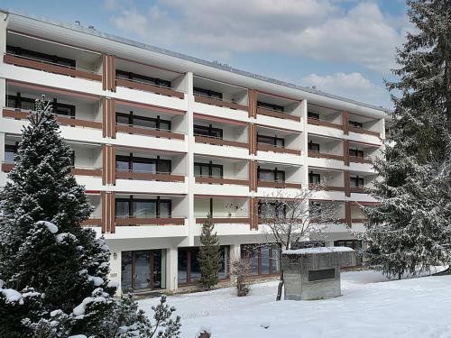 an apartment building with snow in front of it at Apartment Nr-14 Haus Astoria by Interhome in Lenzerheide