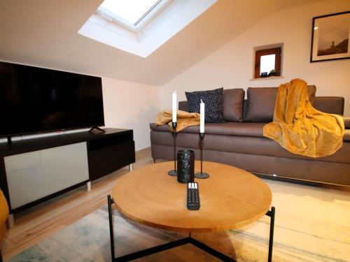 a living room with a couch and a table at Apartment Alberts Huamat by Interhome in Urgen