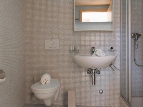 a bathroom with a sink and a toilet at Apartment Residenz Marina by Interhome in Bouveret