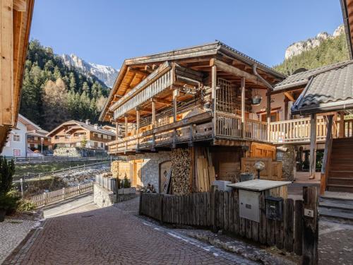 a large wooden house with a balcony on a mountain at Apartment Casa Costazzer B by Interhome in Mazzin