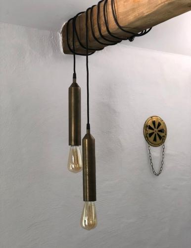 a chandelier with three lights hanging from a ceiling at Ekenäs Gård på Österlen in Kivik