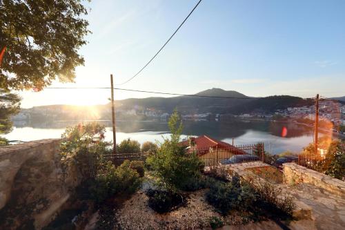 a view of a body of water with the sun setting at Manor House est. 1890 in Kastoria
