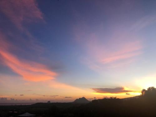 a sunset with a blue and orange sky at Villa Tigo T3 Colibri in Sainte-Luce
