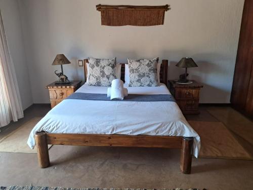 a bedroom with a bed with a teddy bear on it at Makhato Bush Lodge 17 in Bela-Bela
