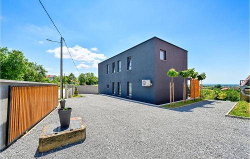 a house on a street with a fence at Beautiful Home In Klostar Ivanic in Kloštar Ivanić