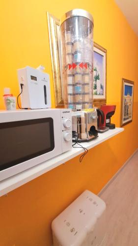 a microwave sitting on a shelf in a room at Affittacamere Miri in Cagliari