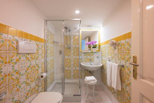 a bathroom with a shower and a toilet and a sink at Palazzo Talamo in Positano