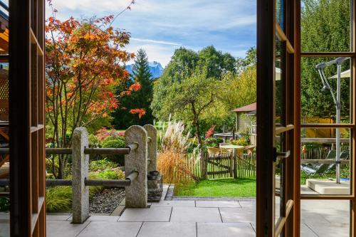 a view of a garden through a door at Chalet Dahoam in Garmisch-Partenkirchen