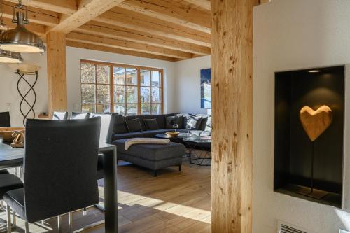 a living room with a couch and a table at Chalet Dahoam in Garmisch-Partenkirchen
