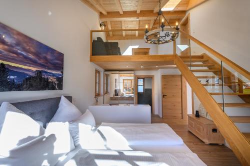 a room with a bed and a staircase at Chalet Dahoam in Garmisch-Partenkirchen
