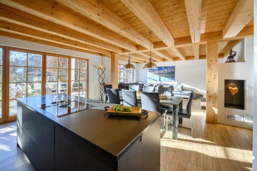 a kitchen with a large island with black counter tops at Chalet Dahoam in Garmisch-Partenkirchen