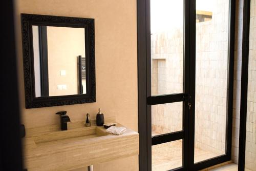 a bathroom with a sink and a mirror at Atlas Retreat Luxury Bed and Breakfast in Beni Mellal