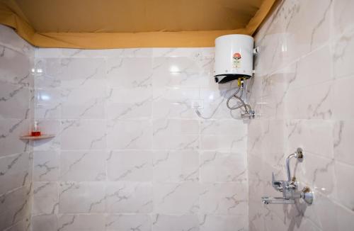 a bathroom with white marble walls and a shower at Desert Vista Camp Jaisalmer in Jaisalmer