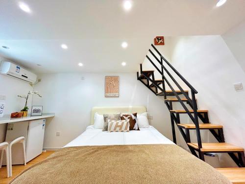 a bedroom with a bed and a spiral staircase at HuaJian in Shanghai