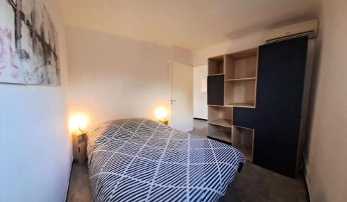 - une chambre avec un lit et une armoire noire dans l'établissement Les Virgiles Ste-Maxime, appt climatisé pour 4 pers avec vue sur la piscine, parking, à Sainte-Maxime