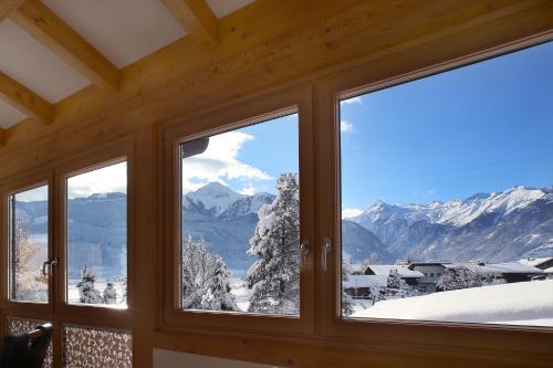 a window with a view of snow covered mountains at Gästehaus Trixl in Zell am See