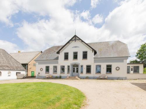 a large white house with a large yard at Lindenhof in Ahneby