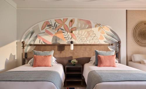 two beds in a hotel room with a large headboard at Grand Hyatt La Manga Club Golf & Spa in La Manga del Mar Menor