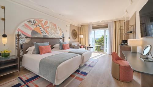 a bedroom with a large bed and a desk at Grand Hyatt La Manga Club Golf & Spa in La Manga del Mar Menor