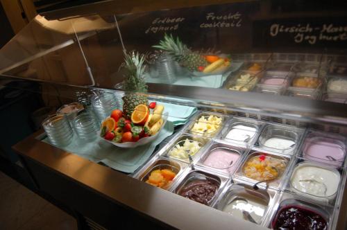 a refrigerator filled with lots of different types of food at Hotel Deichvoigt in Cuxhaven