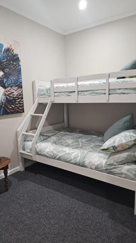 a bedroom with two bunk beds in a room at Lyndoch Retreat, 2BR with Pool, BBQ & Fire Pit in Altona