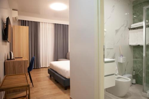 a hotel room with a bed and a toilet at Vatican Bliss in Rome