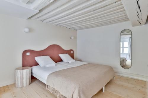 a bedroom with a large bed in a white room at NOCNOC Le Trianon in Lyon