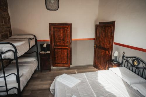 a room with two bunk beds and two chests at Locanda Del Duca in Gubbio