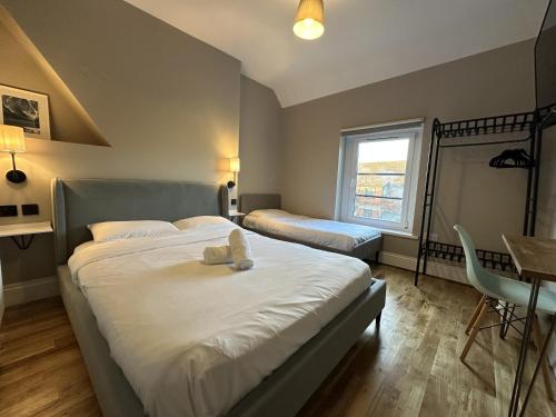 a bedroom with a bed with a teddy bear on it at The Riverhouse in Cardiff