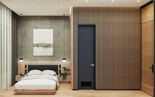 a bedroom with a large bed and a black door at Caldwell Boutique Hotel in Legazpi