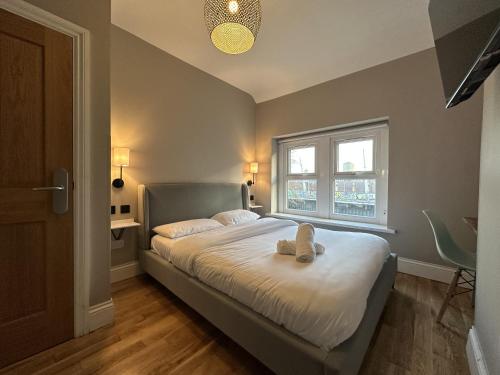a bedroom with a bed with two teddy bears on it at The Riverhouse in Cardiff