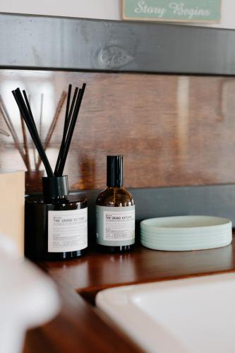 two bottles of essential oils sitting on a wooden table at Hephzibah Inn River Cabin in Hermon