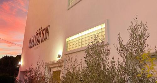 a building with a sign on the side of it at Blanc Sable Hôtel in Golfe-Juan