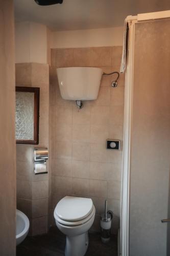 a small bathroom with a toilet and a sink at Locanda Del Duca in Gubbio